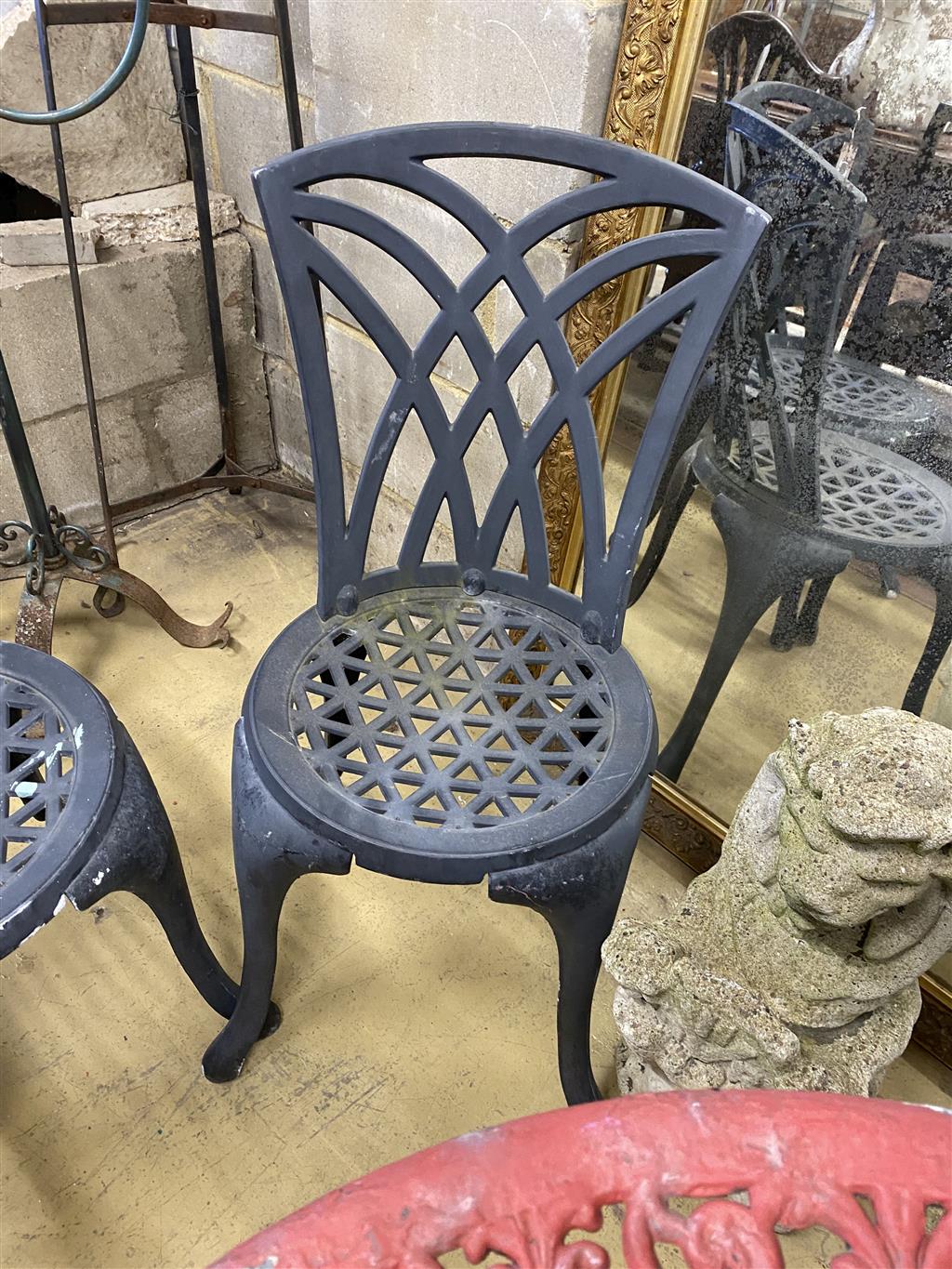 A circular painted aluminium garden table, 60cm diameter together with two garden chairs